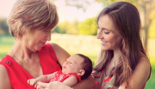 baby credits woman holding a small baby with another woman looking on
